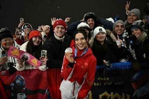 Eileen Gu smiled with her fans after winning her second silver medal of the Milan-Cortina Winter Olympics. She has one more chance of gold
