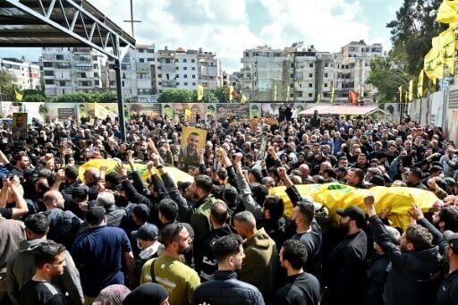Mourners carry the flag-draped caskets of members of the Iran-backed militant group Hezbollah who were killed in southern Lebanon
