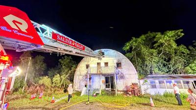 Firefighters work to extinguish a blaze at a vacant building on Old Hwy. 21 in Goldman.