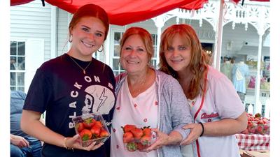 The Imperial Farmers Market sells fresh strawberries at the 2025 Kimmswick Strawberry Festival. Pictured are owner Chris Leach, center, Viviana Lang, left, and Gina Viviano.