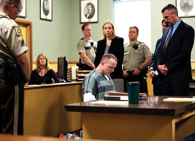Nicholas Sheley, center and kneeling, reads a statement, while surrounded by his attorneys and Sheriff's Office deputies.