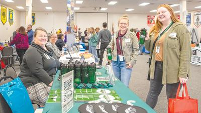 Friends Katie Dolde of Cedar Hill and Hannah Wind of Arnold stop by the Comtrea table to speak about possible openings at last October’s Job Fair.