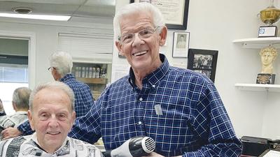 E.J. Pashia, right, has been cutting Marty Duffner’s hair for 66 years. Pashia started cutting hair when he was 16 and graduated from barber school when he was 19.