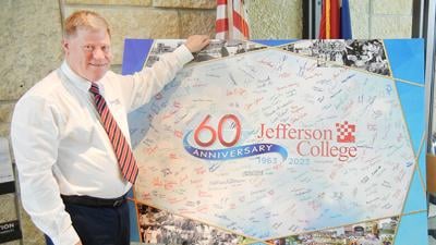 Roger Barrentine, Jefferson College’s director of public relations and marketing, received a giant farewell card from members of the college’s staff.