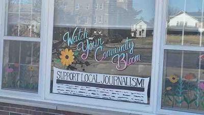 Artist Emily Baker painted the front window of Leader World Headquarters.