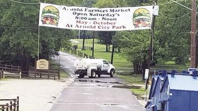 A truck works to clean up at Arnold City Park following flooding this spring and summer.
