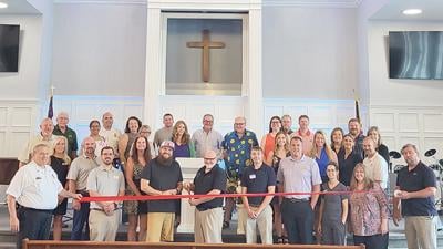 Pastor Dennis Gard cuts the ribbon on the newly remodeled sanctuary at Central Baptist Church in Eureka. Gard is joined by the Eureka Chamber of Commerce.