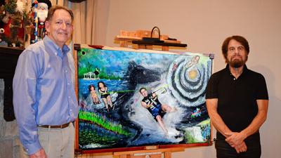 Artist Jeffrey Wind Leiser (right) of Hoene Springs presents his mixed-media painting to Dr. John DuBois, who works at the Eureka Mercy Clinic.