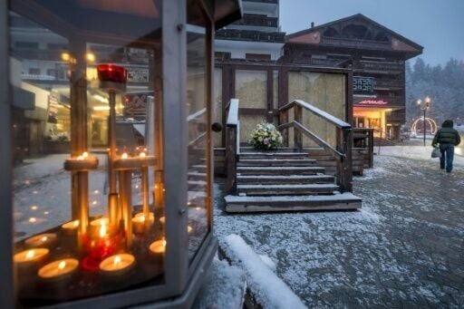 Flowers and candles have been left by the entrance to Le Constellation bar in Crans-Montana