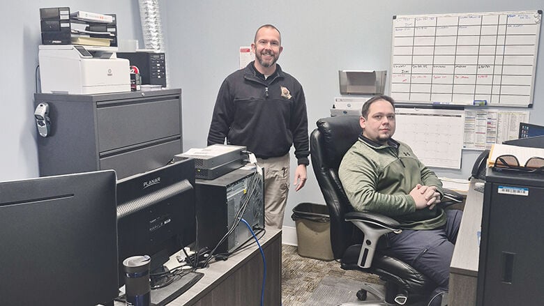 Jefferson County Sheriff’s Office Cpl. Shane Frazier, left, and Arnold Police Detective Clinton Bequette examined 168 mobile phones, 17 hard drives, and 19 other devices from vehicles to flash drives in 2024.