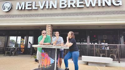 Melvin Brewing brewer Kris Wangelin, left, investment group leader Mike Golomb and investor Sophia Garland outside the Eureka brewery and restaurant.