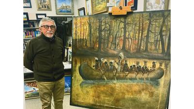 Irek Szelag restored the painting, “Early Days on the Mississippi River,” for the Kimmsiwck Historical Society.