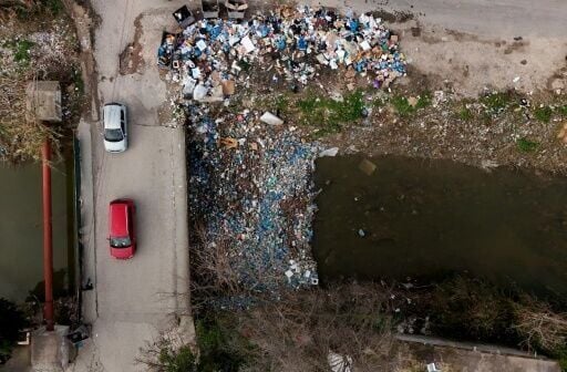An aerial photo of plastic trash build-up by a bridge in Durres