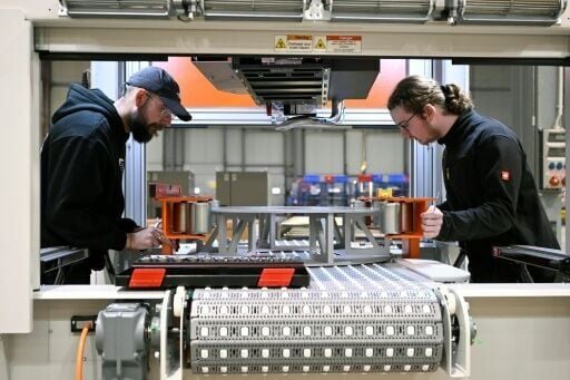 Employees work at a machine at the German firm 4JET
