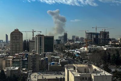 A plume of smoke rises above Tehran on Feb. 28, 2026.