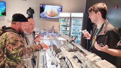 Adam Mire, general manager of N’Bliss in House Springs, helps customers