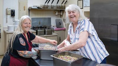 Sandy Colatskie of House Springs, left, and Linda Davis of High Ridge wrap the cole slaw to stay cold until the High Ridge Elks fish fry begins.