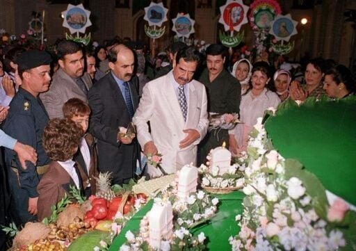 Saddam enjoying a birthday cake in 2000