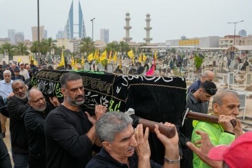 People carry the coffin of a person killed during a drone attack on a high-rise apartment building in Bahrain's capital Manama