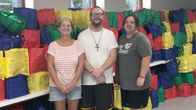 Volunteers, from left, Crystal Lang of Cedar Hill, Adam Boswell of Cedar Hill and Jayme Kositzke of Hillsboro.