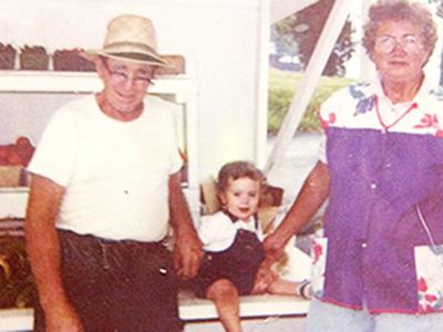 At produce stand Marvin and Esther Keller with a small visitor in the produce stand where they sold the harvest from their Arnold farm from the 1950s until 2018.