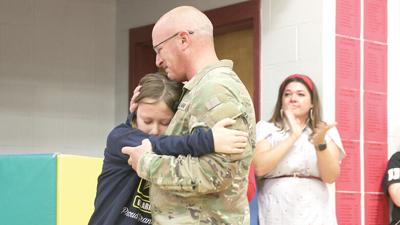Fifth grader Max Miller is surprised with a visit from his grandfather, Staff Sgt. Andrew Casey, at a Veterans Day assembly at Blevins Elementary School.
