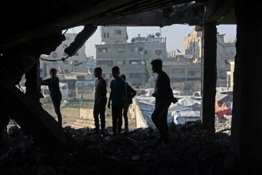 Palestinians inspected the debris of a damaged building in the Zeitoun neighbourhood of Gaza City, the day after a wave of Israeli air strikes