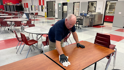 Bob Budwell cleans a table at Meramec Heights Elementary School. He is a substitute custodian for the Fox C-6 School District.