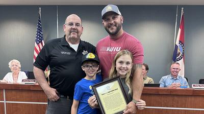 Byrnes Mill Police Chief Frank T. Selvaggio, Phil Barnowski of Cedar Hill and Barnowski’s children, Beau and Maci on Aug. 5.