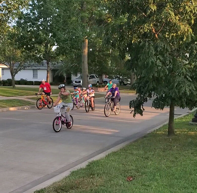 Tour de Twin City Days cyclists riding through Crystal City