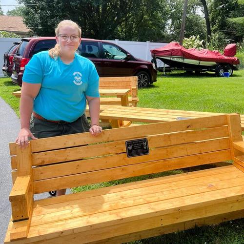 Miranda Machalek displays her Eagle Scout project, benches for the Open Door Animal Sanctuary.