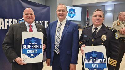 From left, Jefferson County Sheriff Dave Marshak, Gov. Mike Kehoe and Arnold Police Chief Brian Carroll celebrate Arnold and Jefferson County being the first communities to receive the Blue Shield designation during a ceremony on April 24 at Arnold City...