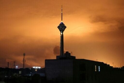 Skies around Tehran's Milad (Birth) Tower, the tallest tower in Iran, are lit up following airstrikes on March 7, 2026