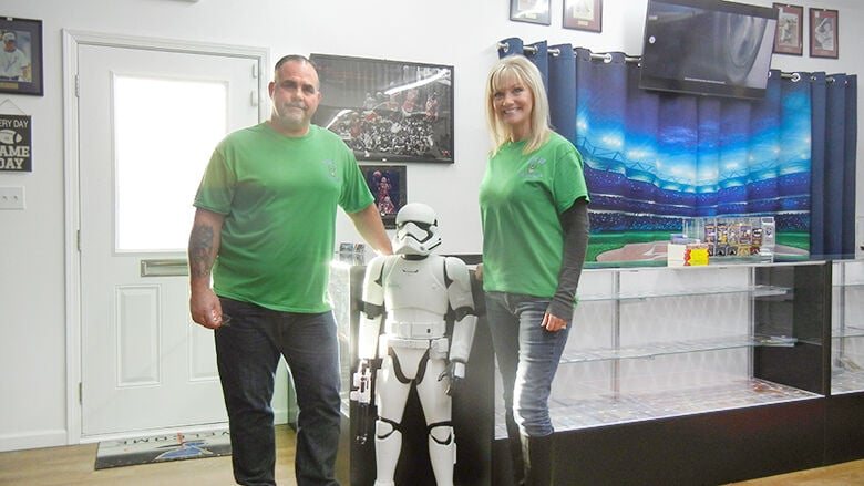 Ken and Karen Martin stand next to a Star Wars Imperial stormtrooper figure at their shop, Score Big Collectibles, in Crystal City.