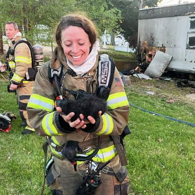Rock Community Firefighter Lane Carl with a kitten she rescued from beneath a burning mobile home in Arnold.