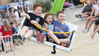 On a ride at the Cedar Hill Community Day are, from left, Henry, 8, Evelyn, 7, and Wyatt Menendez, 4, all of House Springs.