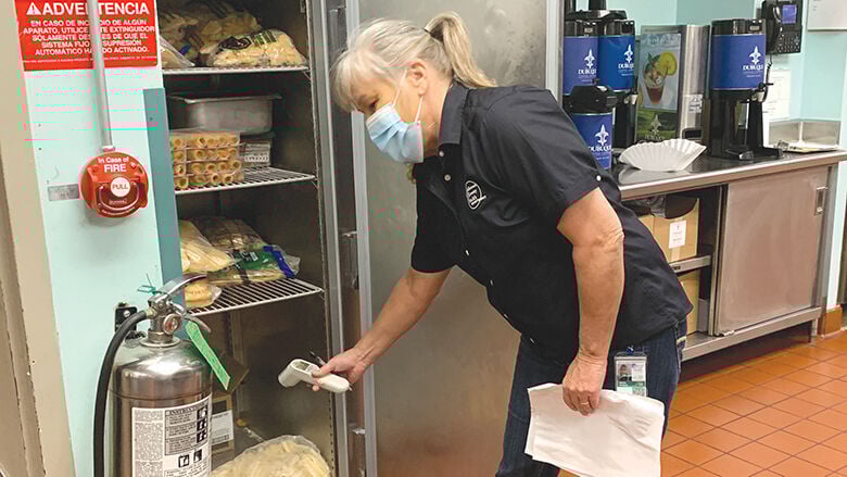 Nancy Radoch, an environmental public health specialist, conducts a routine inspection at a food establishment.