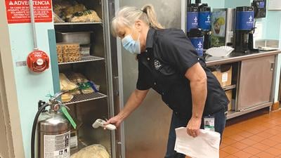 Nancy Radoch, an environmental public health specialist, conducts a routine inspection at a food establishment.