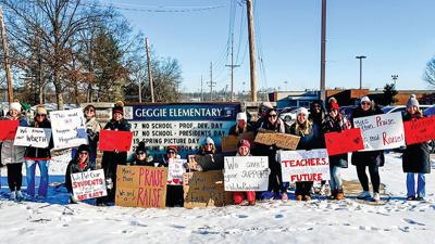 Geggie Elementary School staff gather on Feb. 21 to advocate for higher wages for educators.