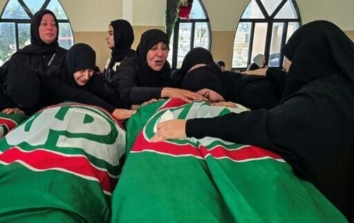 People mourn victims killed earlier this week by Israeli airstrikes in Abbasiyeh on April 10, 2026
