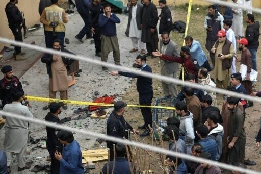 Security personnel and locals gather at the blast site inside a mosque in Islamabad