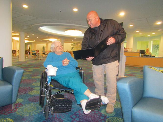 Gladys Johnson receives a certificate of recognition from Jefferson County Sheriff Dave Marshak in February 2019 at Delmar Gardens of Meramec for the kind acts she had done for Jefferson County Sheriff’s Office deputies.