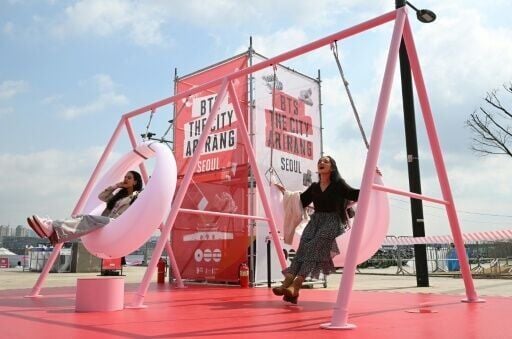 BTS fans enjoy themselves at a fan zone promoting the new album of K-pop boy band BTS at a riverside park in Seoul on March 20, 2026.