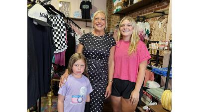 Mandy Rees, center, named her boutique after her daughters, Chaley, left, and Ava. Avaley Jane opened Aug. 8 at 221 E. Main St. in De Soto.
