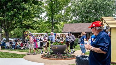People carry the Maypole through Donau Park in House Springs during the German Cultural Society’s Maifest event.