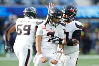 Houston's C.J. Stroud, center, celebrates a touchdown pass with teammate Jake Andrews in the Rexans' 20-16 NFL victory over the Los Angeles Chargers