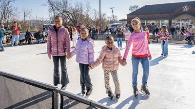 Ariah Petty, 9, with sisters, Alianna, 6, and Amour, 5, and Kierra Roth, 10, all of Festus, skate on the artificial ice rink on Dec. 6 during WinterFest in Festus.