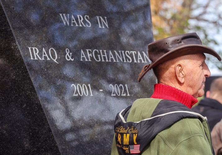 Retired Army Maj. Gen. Hank Stratman stands next to the obelisk dedicated to veterans of the wars in Iraq and Afghanistan