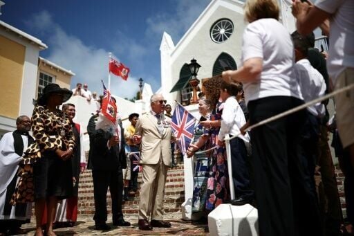 King Charles greeted a line of schoolchildren, pausing to chat with them, on the steps of the whitewashed St. Peter's church
