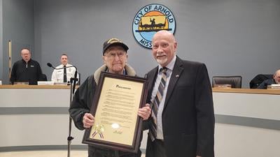 Oscar Masters, left, received a proclamation recognizing his service in the U.S. Army Air Corps and for turning 100 from Arnold Mayor Ron Counts on Dec. 5 during a City Council meeting at City Hall.